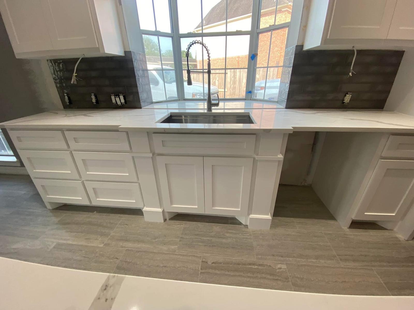 Bay window kitchenette with quartz top Kitchen window area with new quartz countertops and backsplash in a Sugar Land TX home