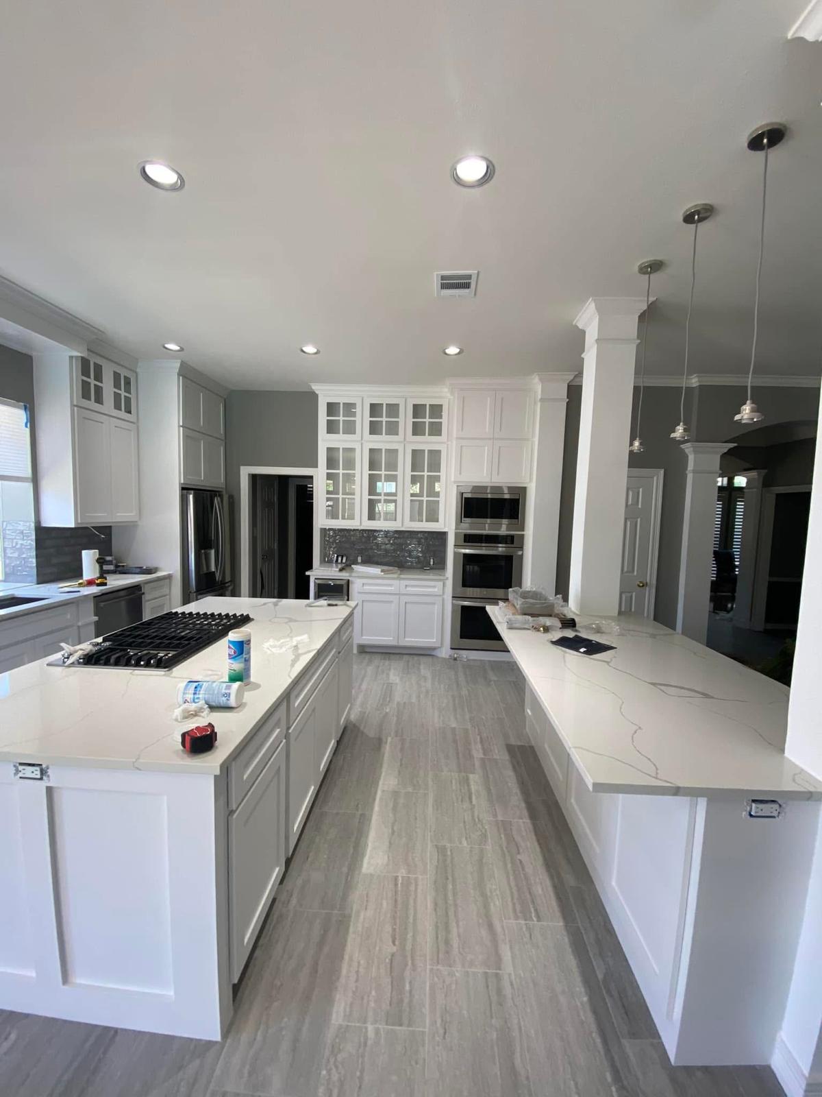 Chef's kitchen with dual quartz islands Bright modern chef's kitchen with dual quartz islands and white cabinetry in Richmond TX